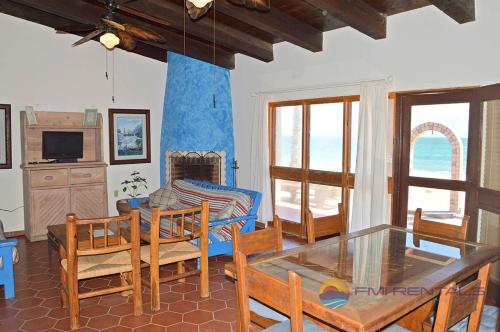 a living room with a glass table and chairs at Casa Chapman by FMI Rentals in Puerto Peñasco