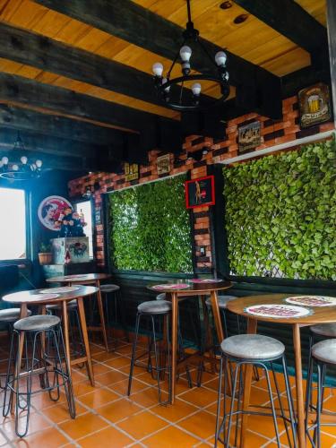 a bar with stools and a green wall at Cabañas Big Mountain in Bernal
