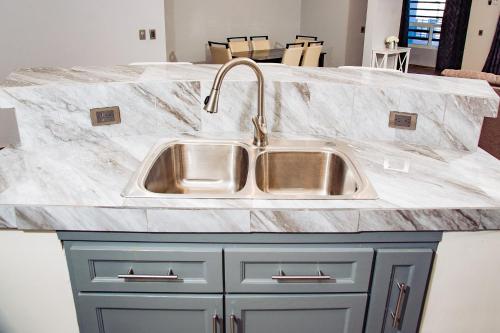 a kitchen counter with a stainless steel sink at Casa Bonita in Puerto Peñasco