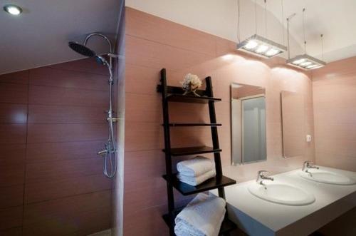 a bathroom with two sinks and a mirror at Deluxe Rhodes Villa Villa Sokaki Well Furnished 2 Bedrooms Lindos in Lindos