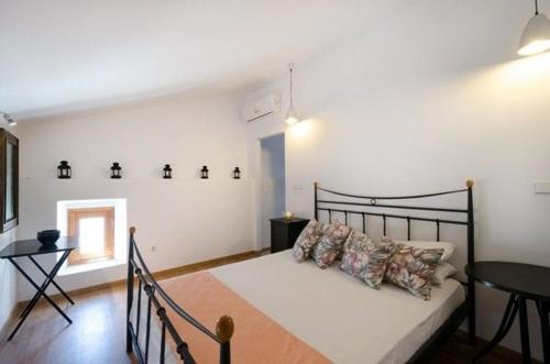 a bedroom with a bed and a table in it at Deluxe Rhodes Villa Villa Sokaki Well Furnished 2 Bedrooms Lindos in Lindos