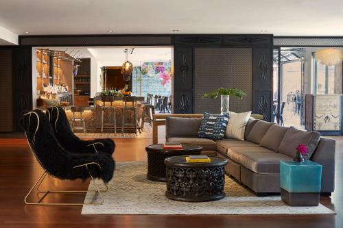 a living room filled with furniture and a large window at Kimpton Shorebreak Huntington Beach Resort, an IHG Hotel in Huntington Beach