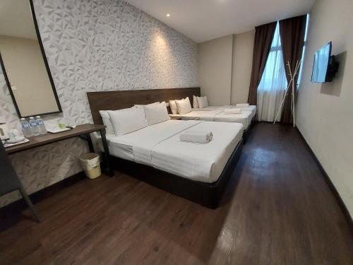 Ένα ή περισσότερα κρεβάτια σε δωμάτιο στο MIICO Hotel @ Mount Austin