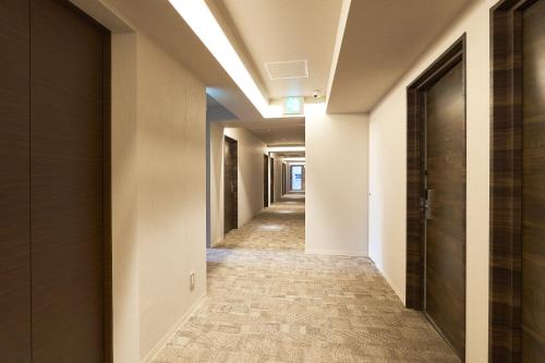 a corridor in a building with a hallway at Hotel Meriken Port Kobe Motomachi in Kobe