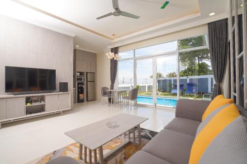 a living room with a couch and a table at Marseillia Hills in Puncak
