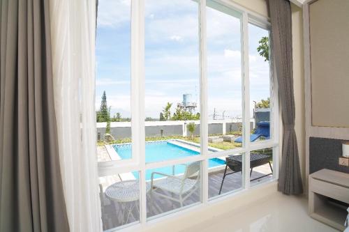a view of a pool from a room with a window at Marseillia Hills in Puncak
