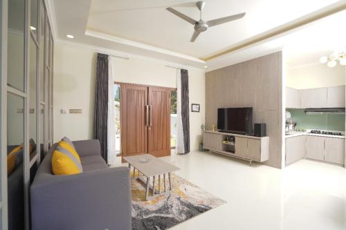 a living room with a couch and a table at Marseillia Hills in Puncak