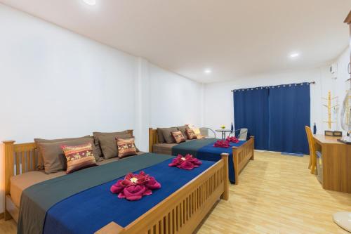 a bedroom with two beds and a couch at Family Song Koh Lipe in Ko Lipe