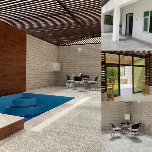 a house with a swimming pool and a patio at Oriental Nights Rest House in Al Wāşil