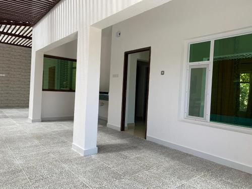 a hallway of a house with two windows at Oriental Nights Rest House in Al Wāşil