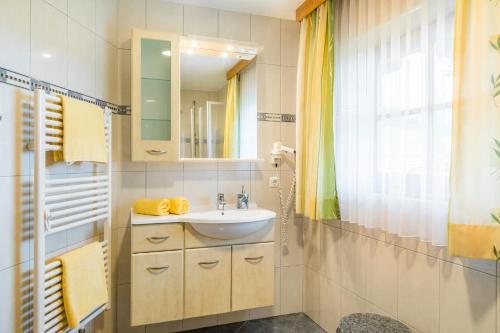 a bathroom with a sink and a mirror at Matzhof in Leogang