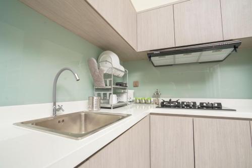 a kitchen with a sink and a stove at Marseillia Hills in Puncak