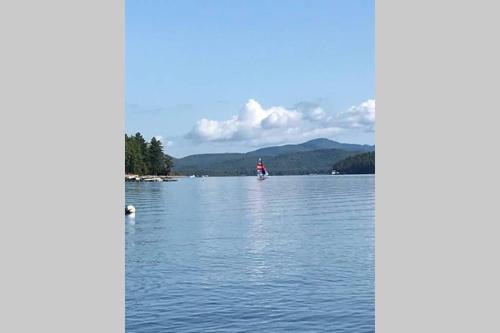 a person in a boat on a lake at Brown's Beach at Schroon Lake in Schroon Lake