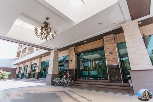 a building with bikes parked outside of it at The Centris Hotel Phatthalung in Phatthalung