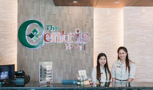 two women standing at a counter in a store at The Centris Hotel Phatthalung in Phatthalung