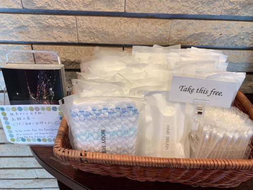 a basket filled with milk and other items on a table at Hotel All In Well in Hakodate