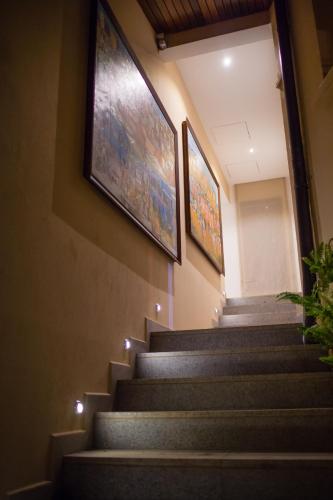 a staircase in a building with two pictures on the wall at La Varangue in Antananarivo