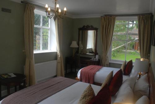 a hotel room with two beds and a window at The Radnorshire Arms Hotel in Presteigne
