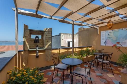 a patio with a table and chairs on a balcony at Aquae Sinis Albergo Diffuso in Càbras