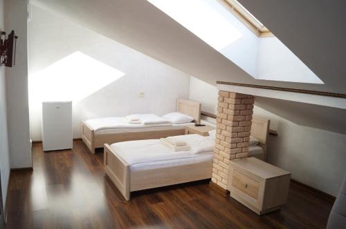 two beds in a room with a attic at Rosinka in Ukrayinka