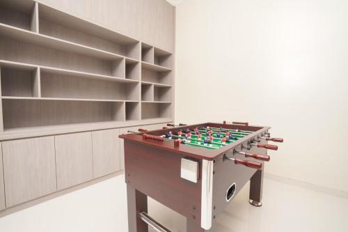 a foosball table in a room with shelves at Marseillia Hills in Puncak