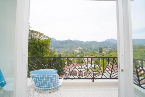 a balcony with a view of the mountains at Marseillia Hills in Puncak