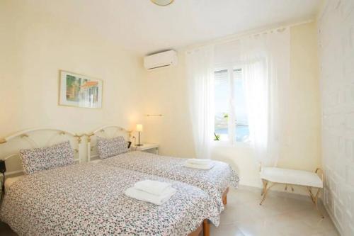 a white bedroom with a bed and a window at Seaview and sun all day long in Los Pinos, Almuñecar, Andalusia in Almuñécar