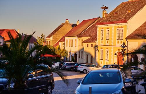 a town with cars parked on a street with buildings at Pension Kral in Rust