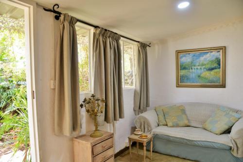 a living room with a couch and windows at Kasane Self Catering in Kasane