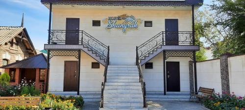 a building with stairs and a sign on it at SHANYRAK Гостевой дом in Aktobe