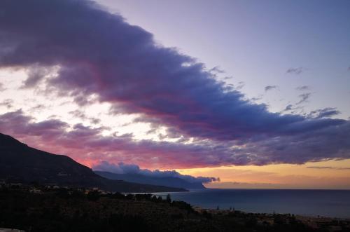 a cloudy sky over the ocean at sunset at La Blanca Resort & Spa in Castellammare del Golfo