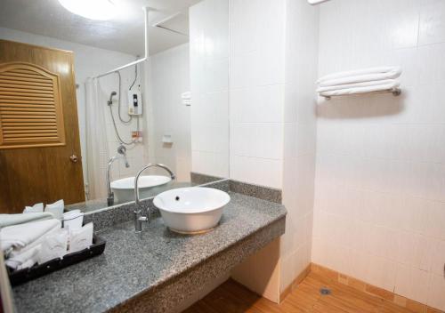 a bathroom with a sink and a mirror at Luckswan Resort Chiang Rai - SHA Extra Plus in Chiang Rai