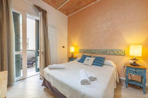 a bedroom with a bed and a large window at B&B Prima Dell'Elba in Piombino