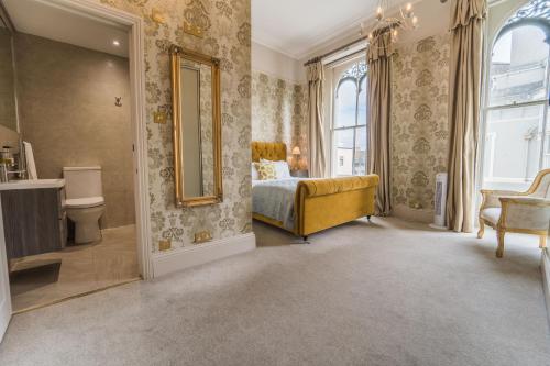 a bedroom with a bed and a mirror at 1 Elliot Terrace in Plymouth