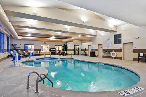 a pool in the middle of a hotel lobby at Holiday Inn Express Hotel & Suites Milwaukee-New Berlin by IHG in New Berlin