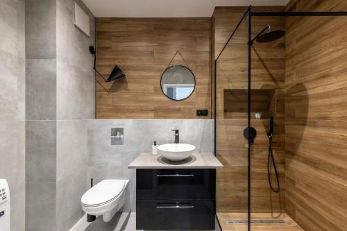 a bathroom with a sink and a toilet and a shower at Warsaw - Aparts Włochy in Warsaw