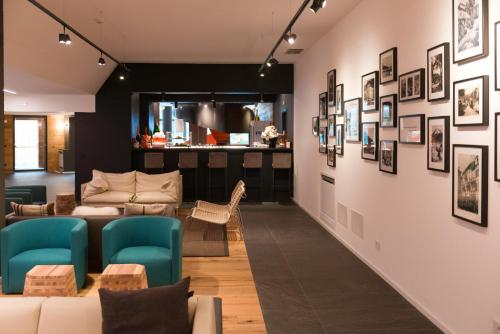 a living room with a couch and chairs at Residence Adamello Resort in Ponte di Legno