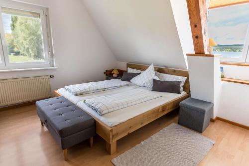 a bedroom with a bed and a large window at Appartement Böhler 1 in Reichenau