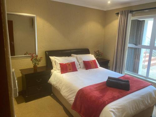 a bedroom with a bed and a large window at Sands Beach Simbithi Eco Estate Luxury Villa in Ballito