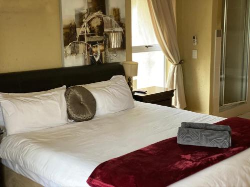 a bedroom with a large white bed with a large window at Sands Beach Simbithi Eco Estate Luxury Villa in Ballito