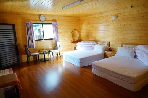 מיטה או מיטות בחדר ב-Yun Hsiang Zhan Chalet