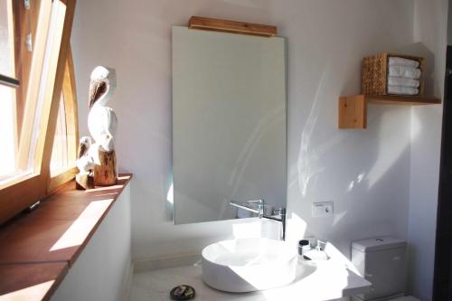 a bathroom with a sink and a mirror at Can Girmas Casa de Turisme rural Navata in Navata