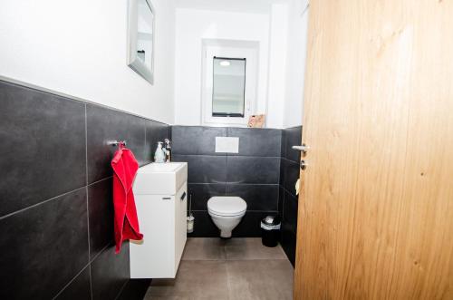 a bathroom with a toilet and a red towel at Kitz Juwel Top 2 in Hollersbach im Pinzgau