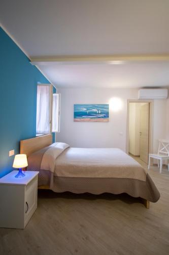 a bedroom with a large bed and a blue wall at Casa Gardan in Levanto