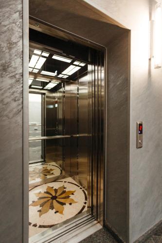 a elevator with a mirror in a room at Nicole in Uzhhorod