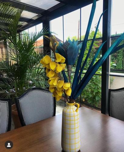 a yellow vase with a bunch of fruit in it on a table at Lagun Palas in Yalova