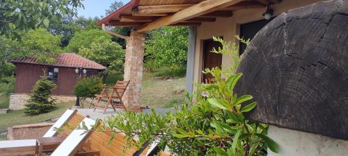 a porch of a house with a table and chairs at DIMITRA's VILLAS in Elatochori