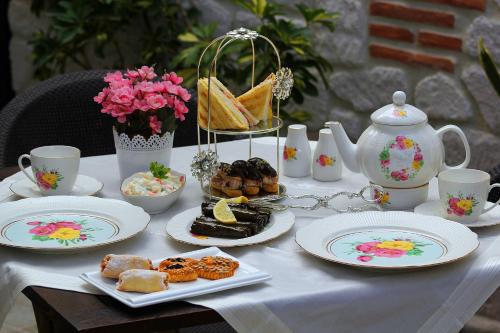 a table with plates of food and a tea pot at Lagun Palas in Yalova
