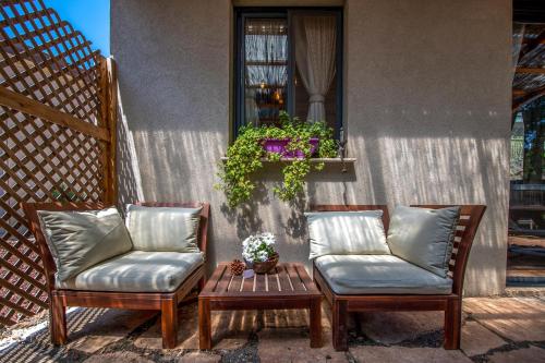 two chairs and a table on a patio at Gate Away B&B Units - המקום באל רום in El-Rom