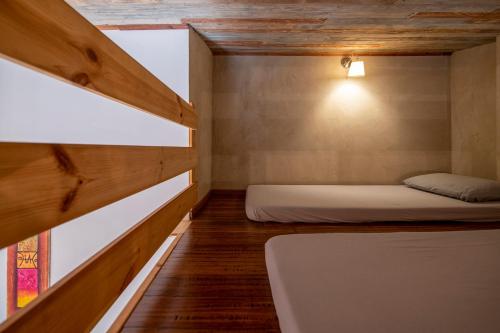 a small room with two beds and a window at Gate Away B&B Units - המקום באל רום in El-Rom